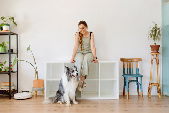 A woman and her dog in a living room