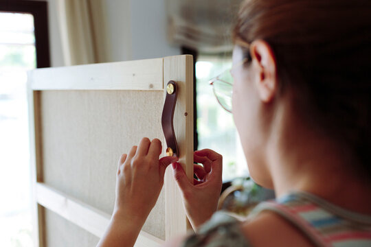 Woman installing door pulls