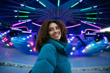 Smiling woman at amusement park