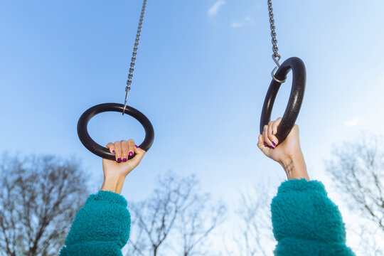 Female hands on gymnastic rings