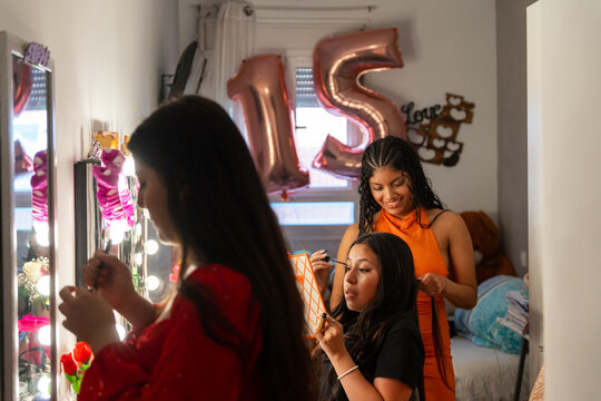Latina Teen Friends Getting Ready For A Quinceanera Birthday Party. 