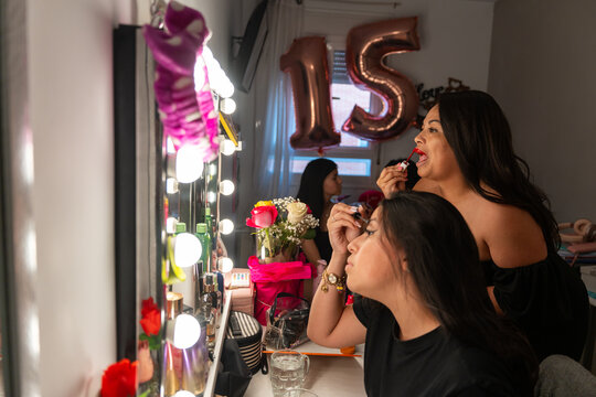 Latina Teen Friends Getting Ready For A Quinceanera Birthday Party. 