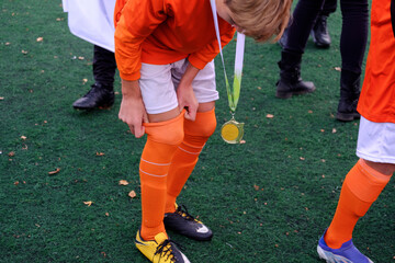 winner of soccer match with golden medal 