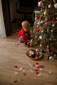 holidays background wItH boy decorated christmas tree