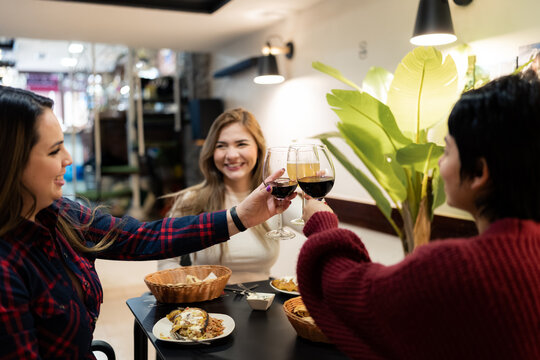 Friends toasting at restaurant.