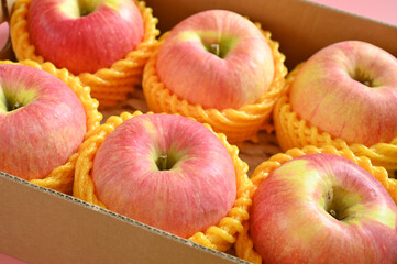 beautiful pink apple in yellow wrap bubble, healthy fruit in the box