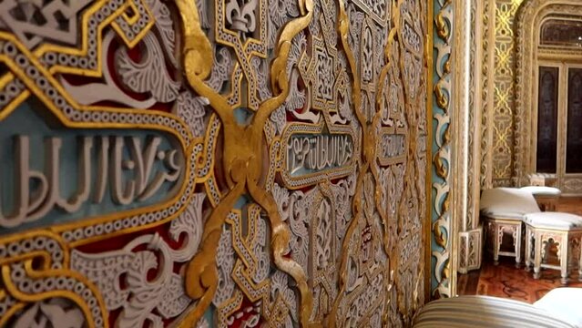 Colorful reliefs and Arabic characters of Arabic Room in Palacio da Bolsa, Porto. Handheld