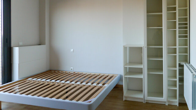 Empty bedroom with only mattress base empty shelf
