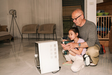 DIY Adventure. Grandfather And Granddaughter Disassembling Microwave
