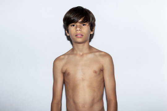 Portrait of a twelve year old boy without a shirt