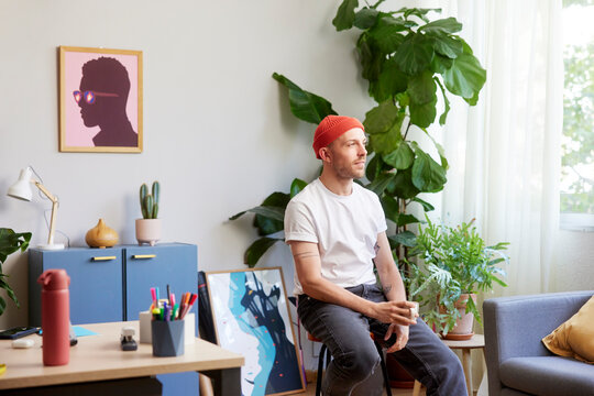 Pensive freelancer having coffee at home office