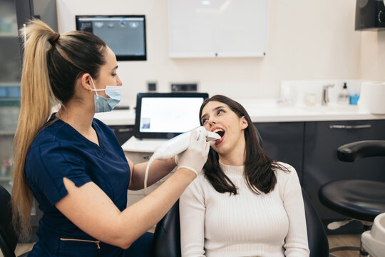 Dentist doing a 3D scan to a patient