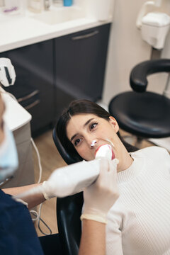 Dentist using an intraoral scanner with a patient