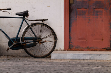 Fototapeta na wymiar Bicycle against wall on street. Beijing, China