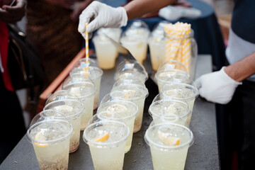 A man prepares fresh juices to sell at the food market