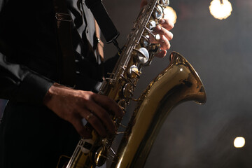 Saxophone man. Saxophonist hands and saxophone.