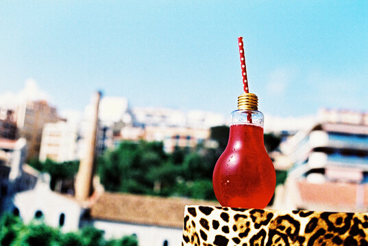 red cocktail in a lightbulb-shaped glass, 35mm film