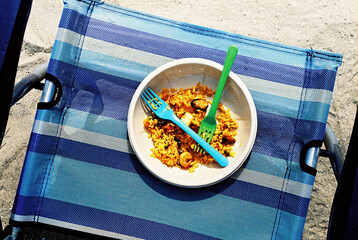 plate with paella on a beach chair, 35 mm film