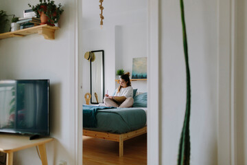 Woman studying in her bedroom