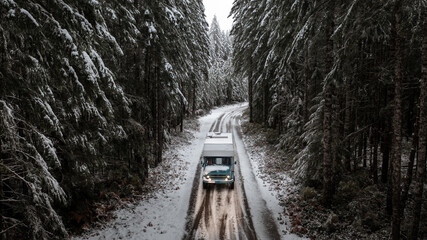 blue adventure mobile in snowcovered forest in british columbia