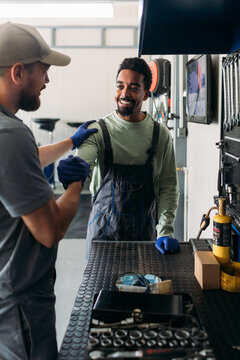 Two Men Working in Car Garage 
