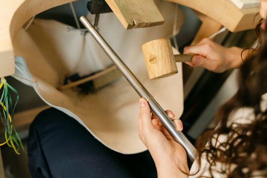 close up  of young woman working in hammering a ring to make it bigger