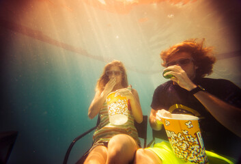 Couple watching movies inside swimming pool