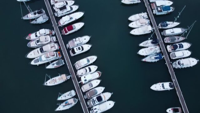 Aerial top down shot showing luxury boats and Yacht parking at Novigrad Marina during sunset time