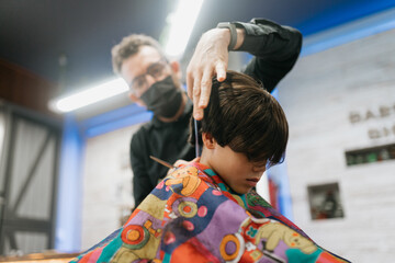 Barber Confidently Cuts Child's Hair