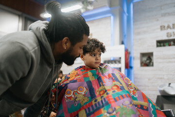 Father talking to son after haircut