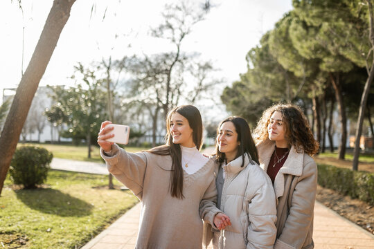 female friends taking a selfie outdoors in the university campus