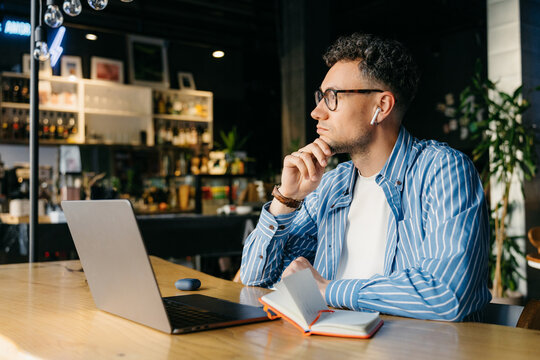 A man with a laptop in a cafe