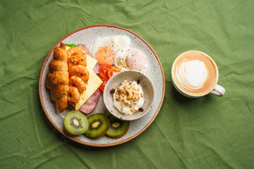 Breakfast sandwiches, croissants, ham, cheese, shrimp, fried eggs and yogurt.