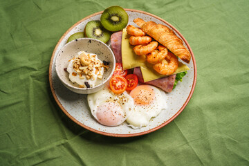Breakfast sandwiches, croissants, ham, cheese, shrimp, fried eggs and yogurt.