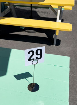 Number 29 at picnic table at outdoor summer dining restaurant sign