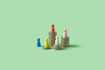 Colorful game pawns on stacks of coins.