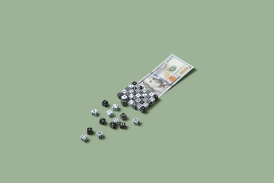 Dollar bill covered with many black and white dice.