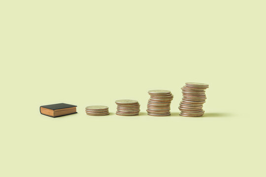 Row of miniature book and coins piles.