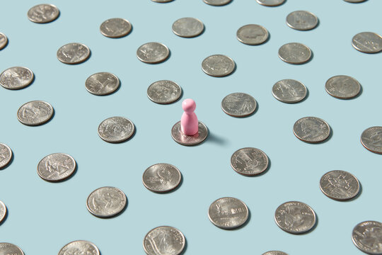 Single pink game chip on group of cent coins.