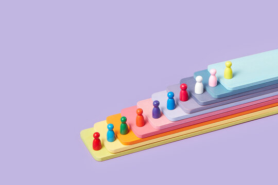 Multicolor game pieces on wooden panels of rainbow colors.