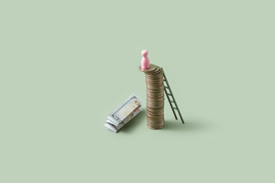 Coin stack with game piece and dollar banknote