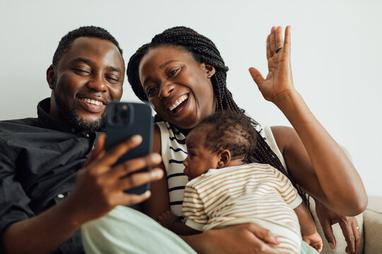 Family with Newborn Baby on Video Call