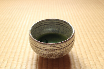 Matcha tea cup on tatami mat blur background