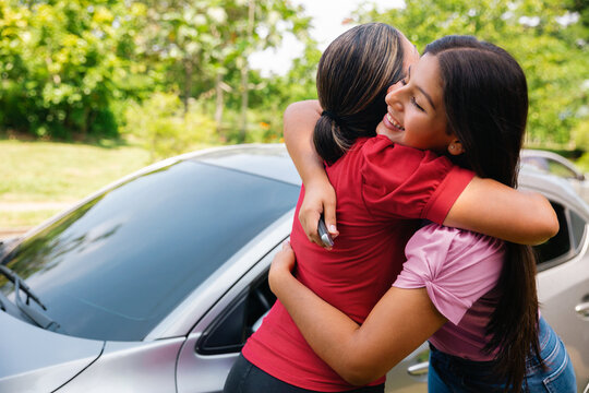 Daughter hugs her mother after receiving a present
