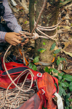 Anonymous hands tying an anchor knot