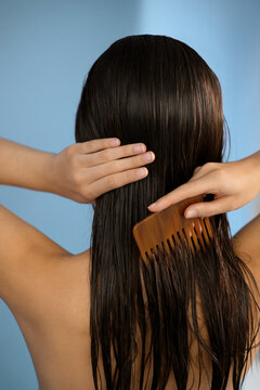 Woman brushing wet hair with comb. Summer portrait