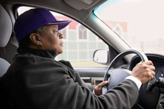 Portrait of an over 50 black woman driving a car