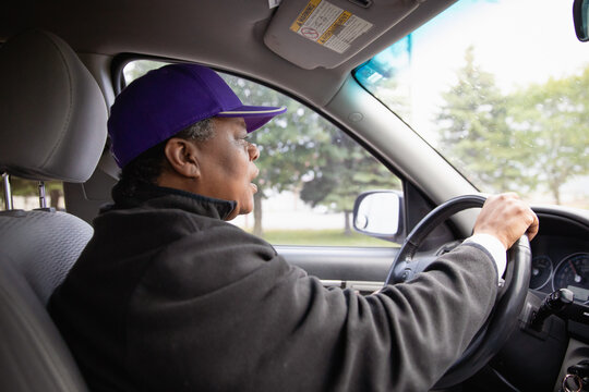 Portrait of an over 50 black woman driving a car