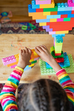 Child building a structure from blocks type blocks