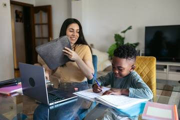 Teacher giving private lessons to little boy at home